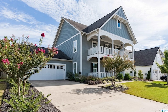 view of front of property with a garage, a balcony, and a front yard