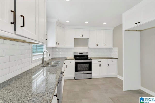 kitchen featuring light stone countertops, stainless steel appliances, decorative backsplash, and sink