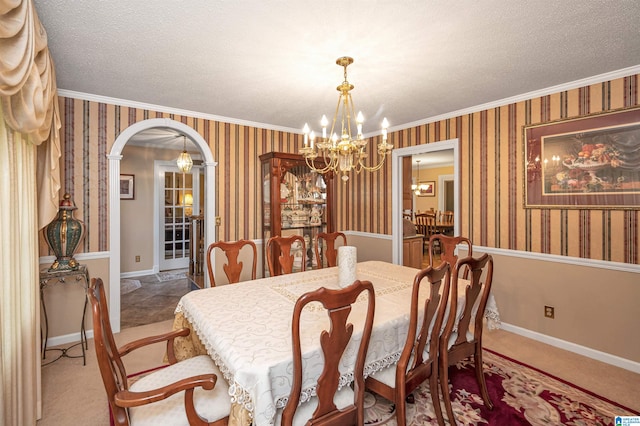 carpeted dining room featuring a textured ceiling, crown molding, and a chandelier