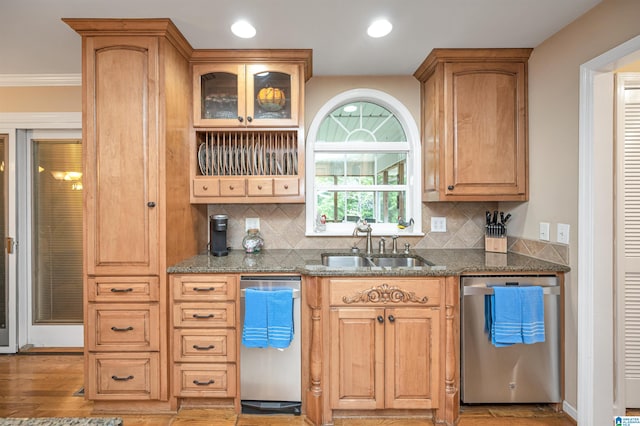 kitchen featuring dishwasher, sink, crown molding, and light hardwood / wood-style flooring