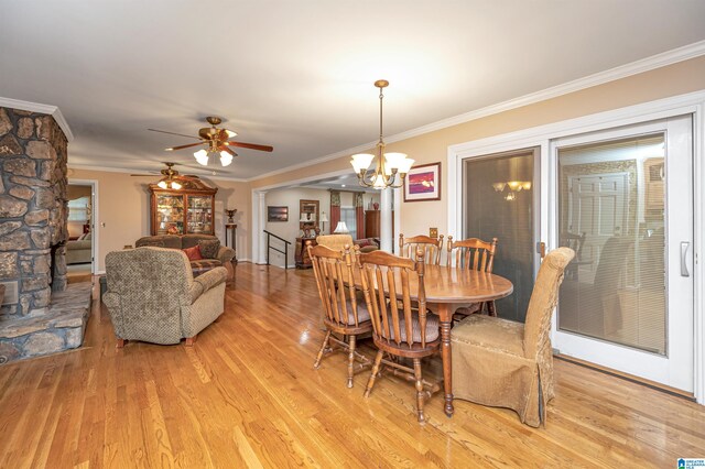 dining area with crown molding, light hardwood / wood-style flooring, and ceiling fan with notable chandelier