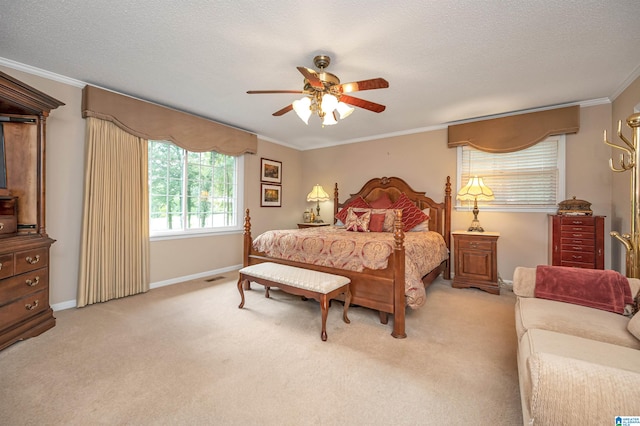 bedroom with a textured ceiling, light colored carpet, ceiling fan, and crown molding