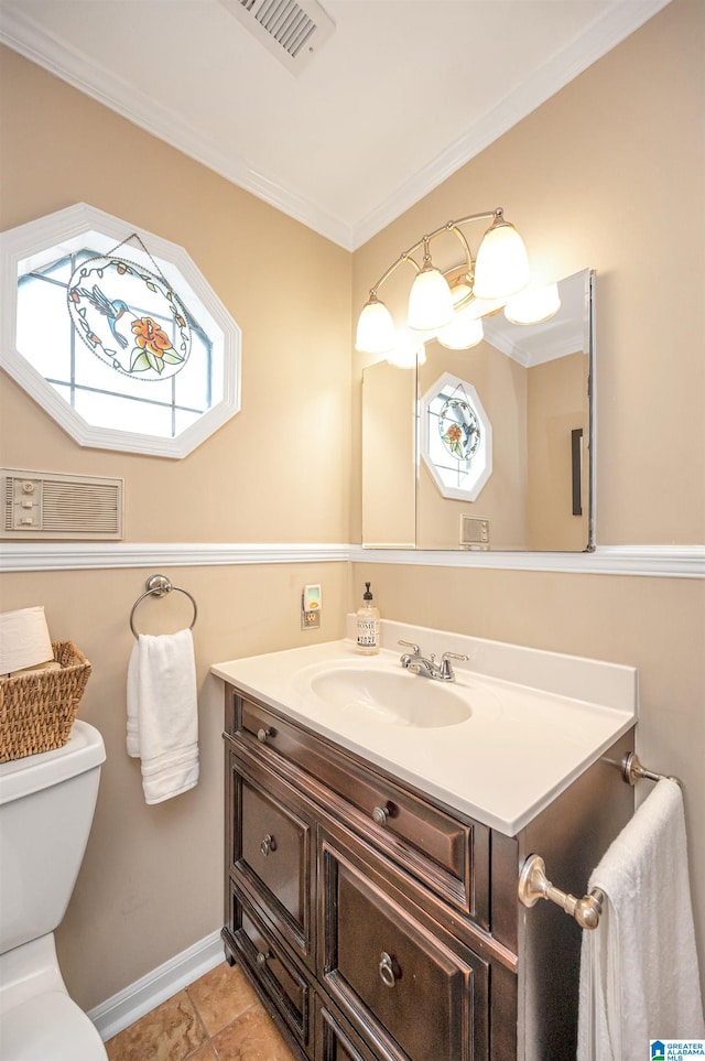 bathroom featuring tile patterned flooring, vanity, toilet, and ornamental molding