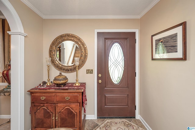 foyer with crown molding and a textured ceiling