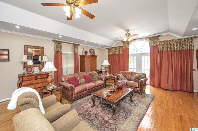 living room featuring lofted ceiling, ceiling fan, light wood-type flooring, and crown molding