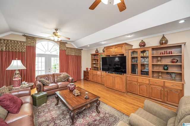 living room featuring ceiling fan, ornamental molding, vaulted ceiling, and light hardwood / wood-style floors