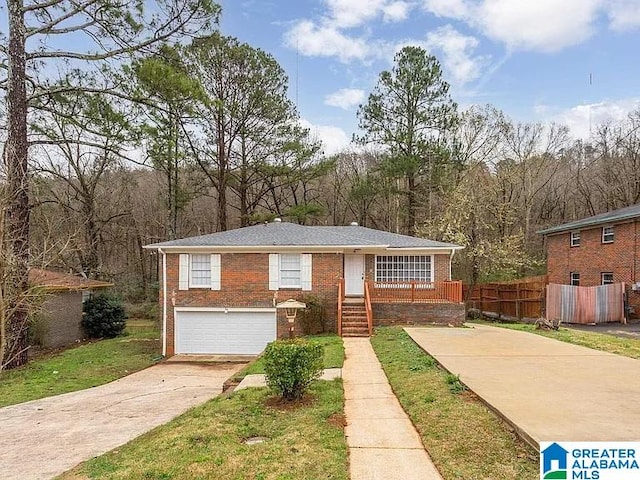 view of front of house featuring driveway, an attached garage, fence, and brick siding