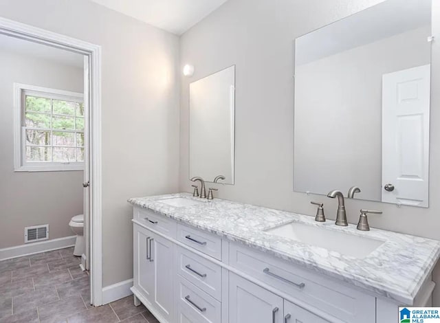 bathroom featuring vanity and toilet