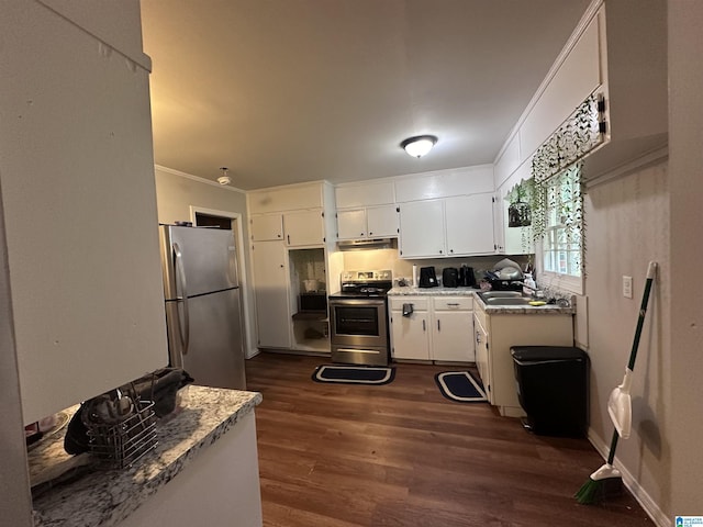 kitchen with crown molding, appliances with stainless steel finishes, dark wood-type flooring, white cabinets, and under cabinet range hood