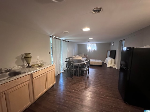 dining area with dark hardwood / wood-style floors and sink