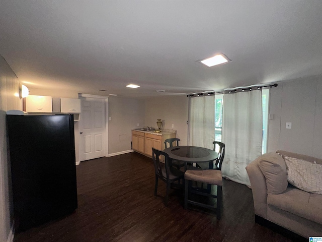 dining space with dark hardwood / wood-style flooring