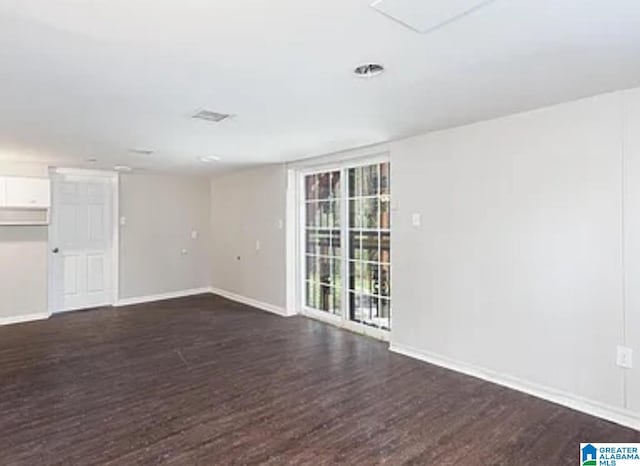 spare room featuring dark hardwood / wood-style floors