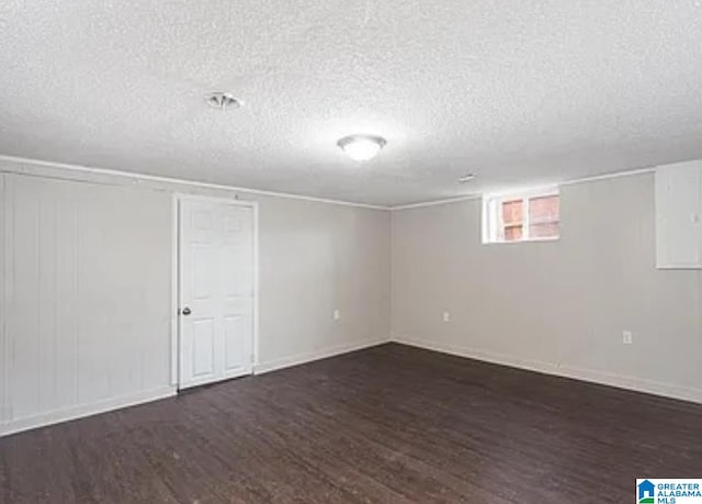 basement with dark wood-type flooring and a textured ceiling