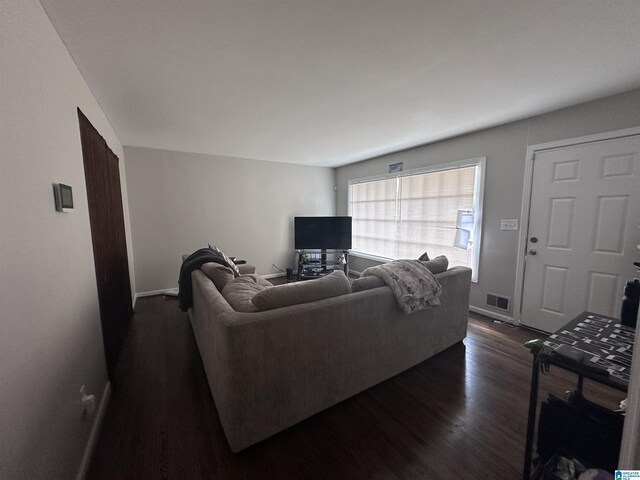 unfurnished room with dark hardwood / wood-style floors and a healthy amount of sunlight