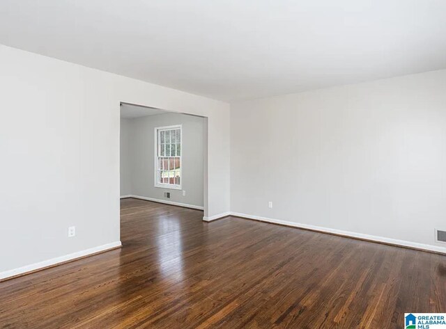 unfurnished room featuring dark hardwood / wood-style floors