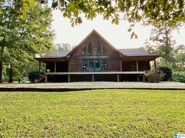 rear view of property with a yard