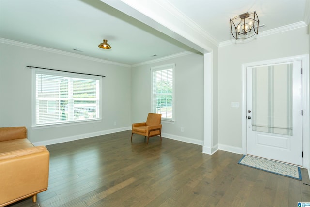 entrance foyer with crown molding, an inviting chandelier, and dark hardwood / wood-style floors