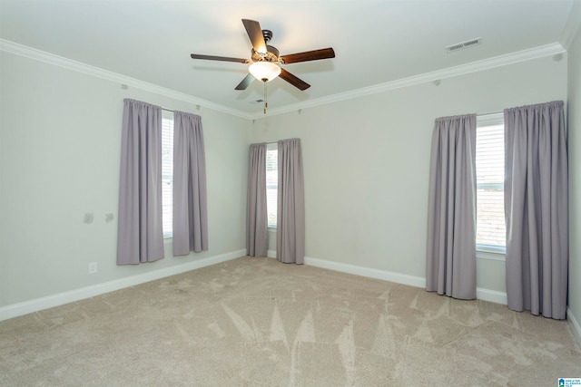 spare room with ceiling fan, plenty of natural light, and light carpet