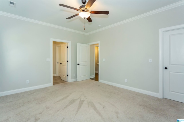 unfurnished bedroom with ornamental molding, light carpet, and ceiling fan