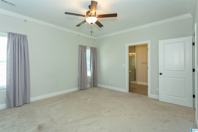 interior space with ceiling fan, light colored carpet, and crown molding