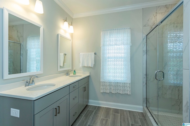 bathroom featuring an enclosed shower, ornamental molding, and vanity