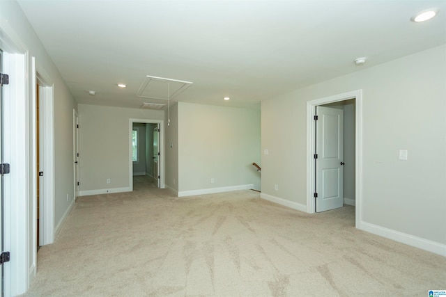 unfurnished room featuring light colored carpet