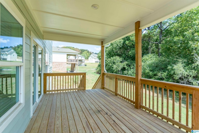 wooden terrace featuring a yard