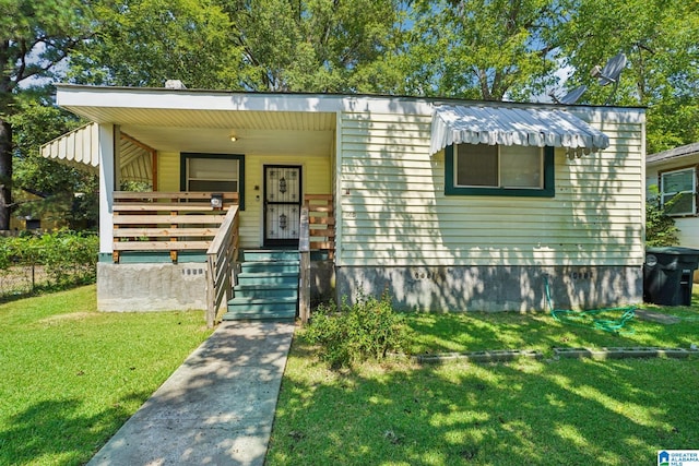 view of front of property with covered porch and a front yard