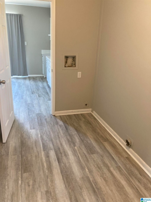 washroom with hookup for a washing machine and wood-type flooring