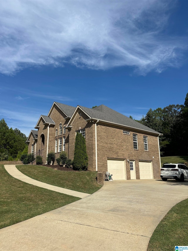 view of home's exterior with a garage and a yard