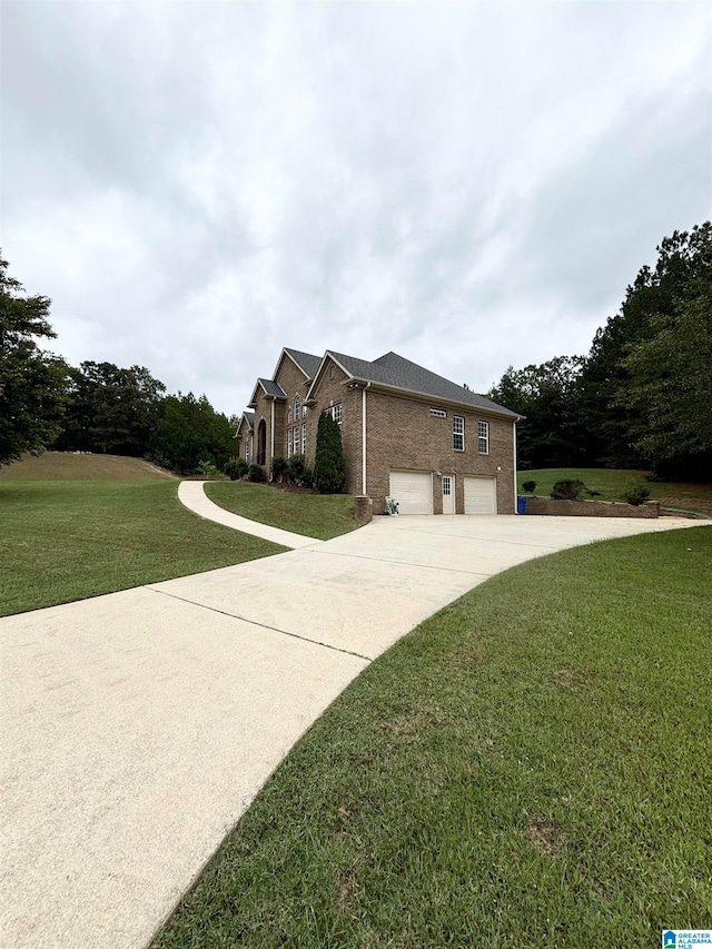 view of front of house with a front yard and a garage