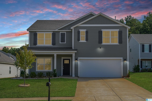 view of front of home featuring a garage and a lawn