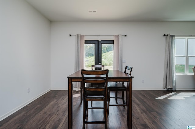 dining space featuring dark hardwood / wood-style flooring and a healthy amount of sunlight