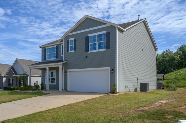 view of front of property featuring a garage, a front lawn, and central air condition unit