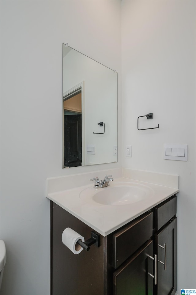 bathroom featuring vanity and toilet