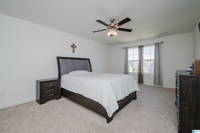 bedroom with ceiling fan and light carpet