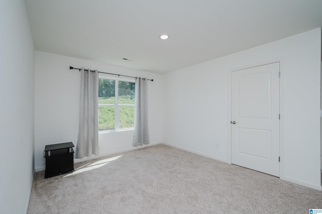 empty room featuring light colored carpet