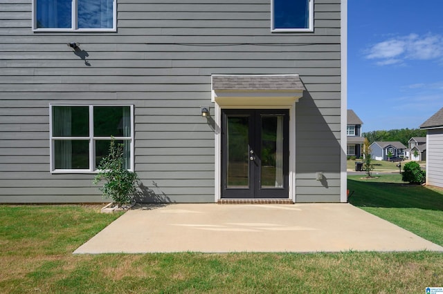 exterior space featuring french doors, a lawn, and a patio