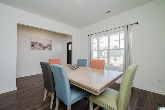 dining space with dark hardwood / wood-style flooring