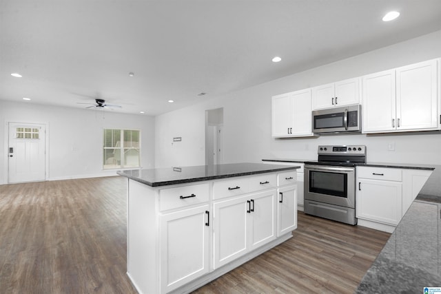 kitchen with white cabinets, ceiling fan, stainless steel appliances, and dark hardwood / wood-style floors