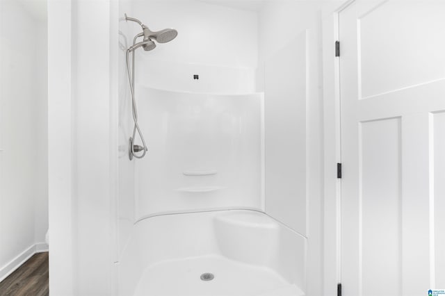 bathroom with walk in shower and hardwood / wood-style flooring