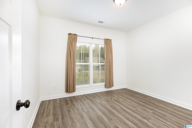 spare room with hardwood / wood-style floors