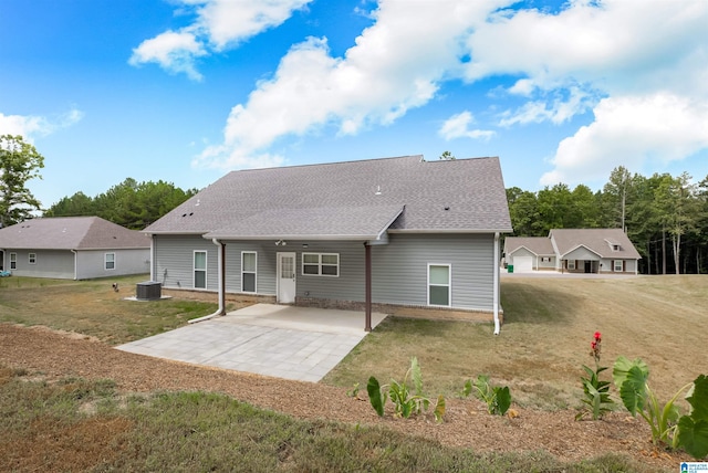 rear view of house with a yard and a patio area