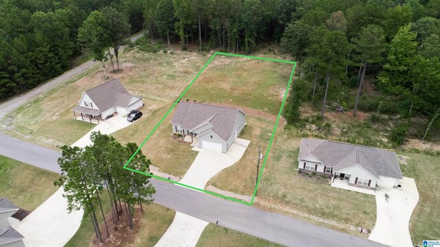 view of front of house featuring covered porch, a garage, and a front lawn