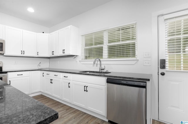 kitchen with appliances with stainless steel finishes, light hardwood / wood-style flooring, sink, and white cabinets