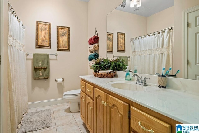 full bathroom with tile patterned floors, a shower with curtain, toilet, vanity, and baseboards