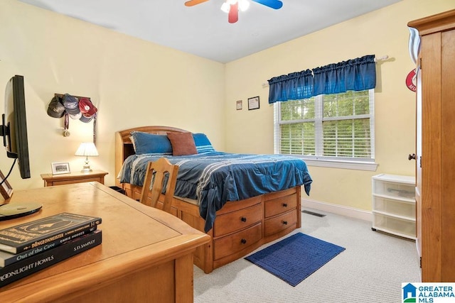carpeted bedroom featuring visible vents, ceiling fan, and baseboards