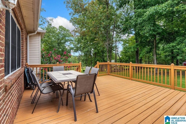 wooden terrace featuring outdoor dining space