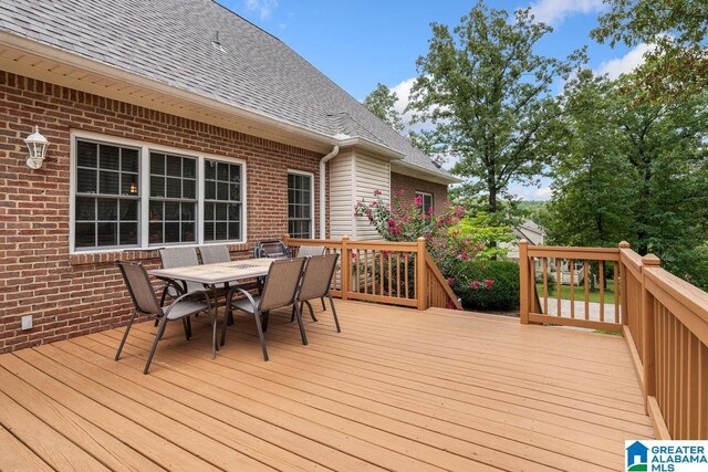 wooden deck with outdoor dining space