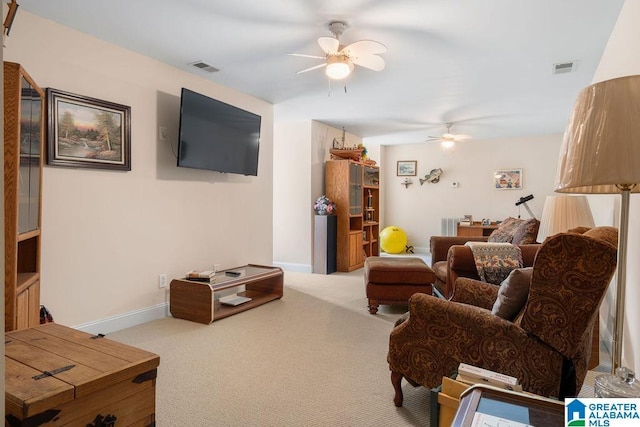 living area with a ceiling fan, visible vents, carpet, and baseboards